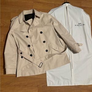 This is a Coach trench coat. Comes with dust storage bag